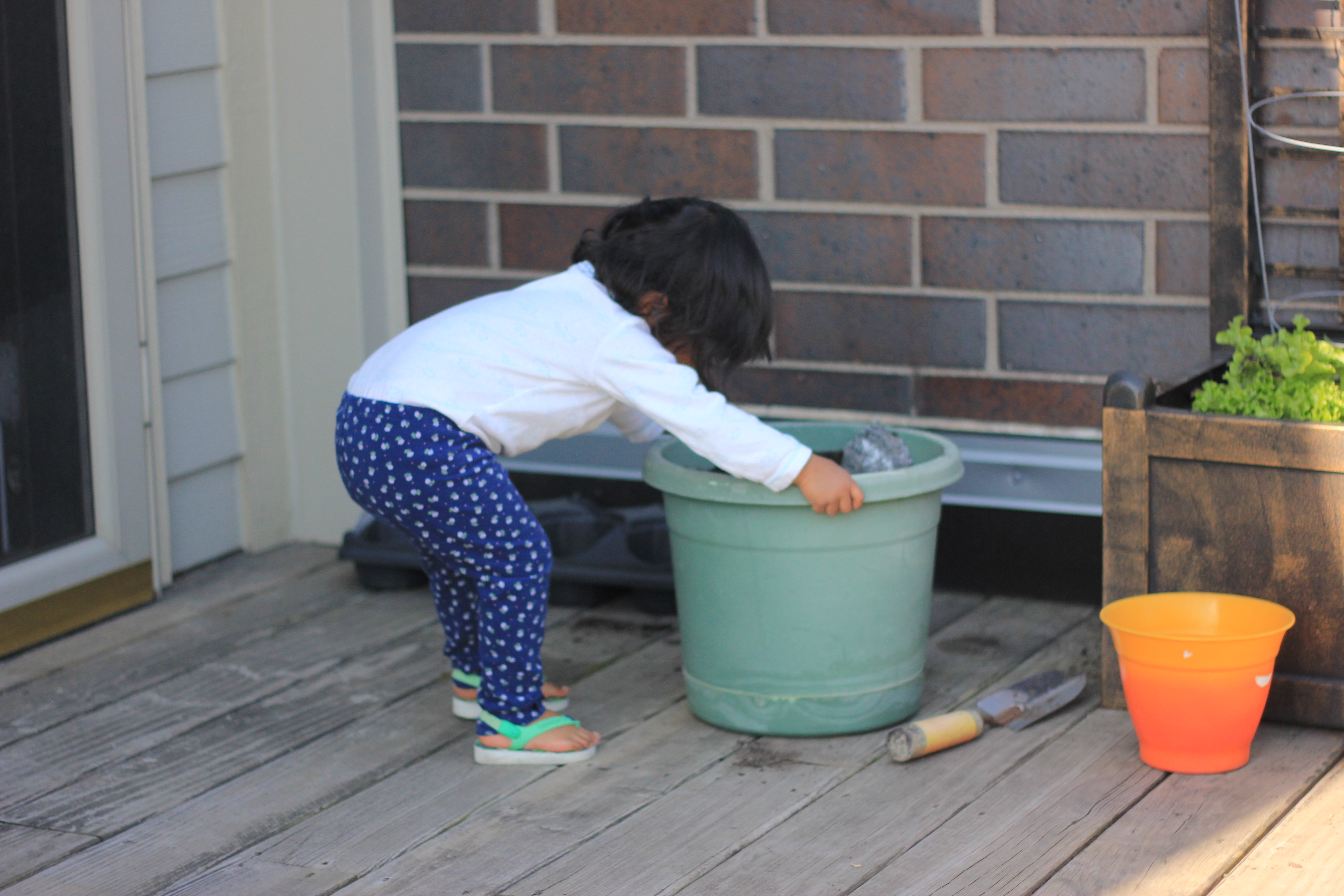 Asha Gardening and playing with dirt