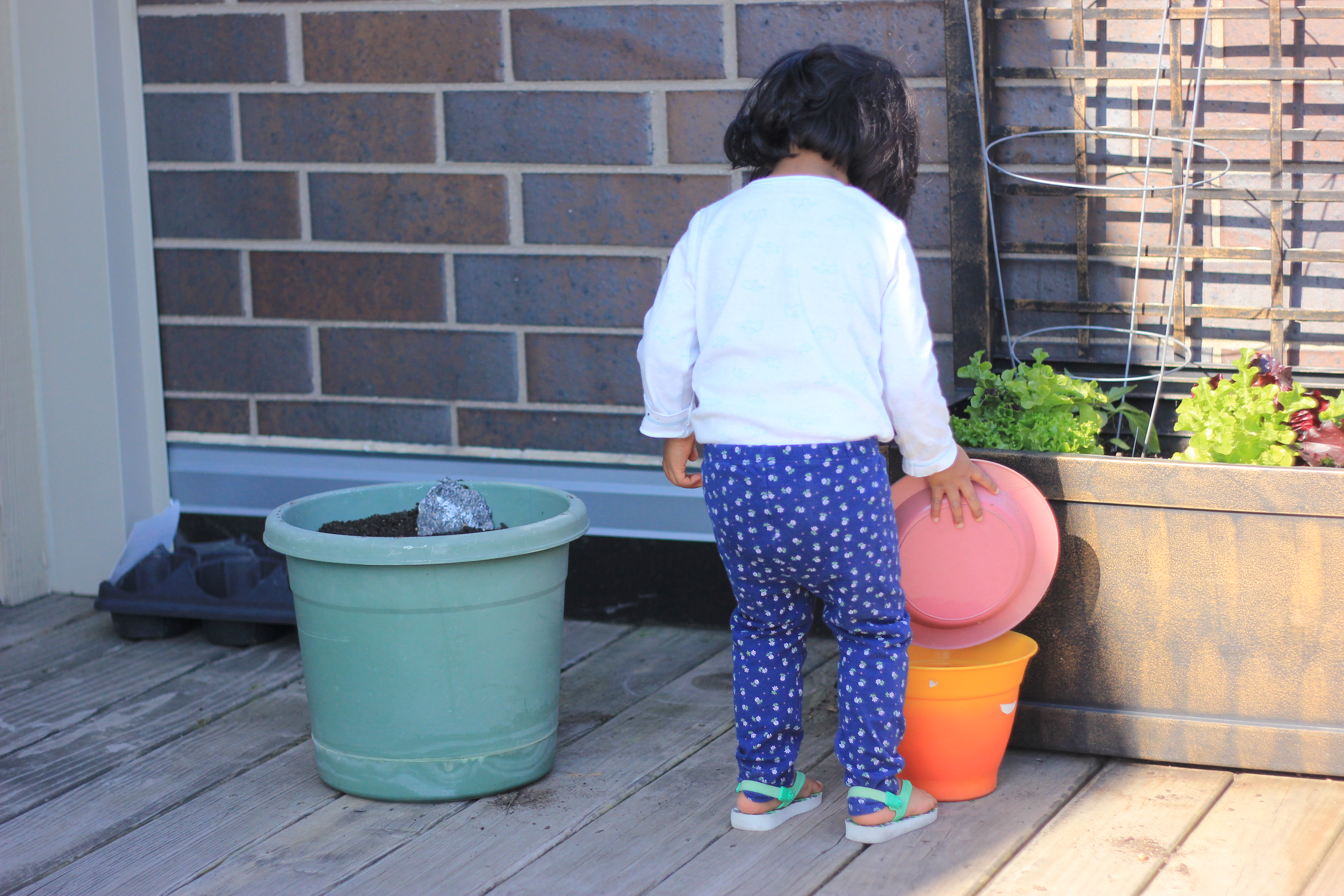Asha Gardening and playing with dirt