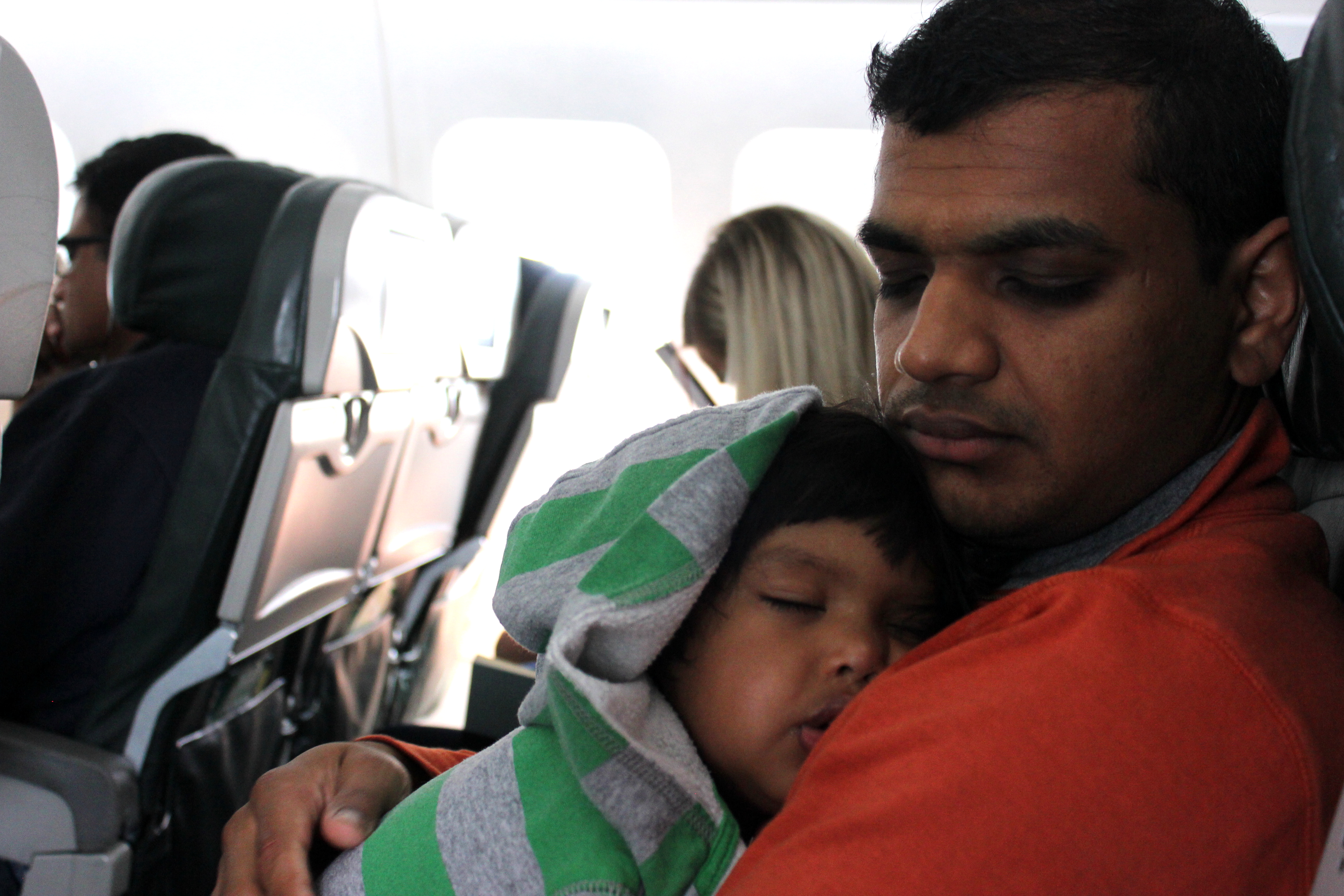 Asha and Devang sleeping on plane