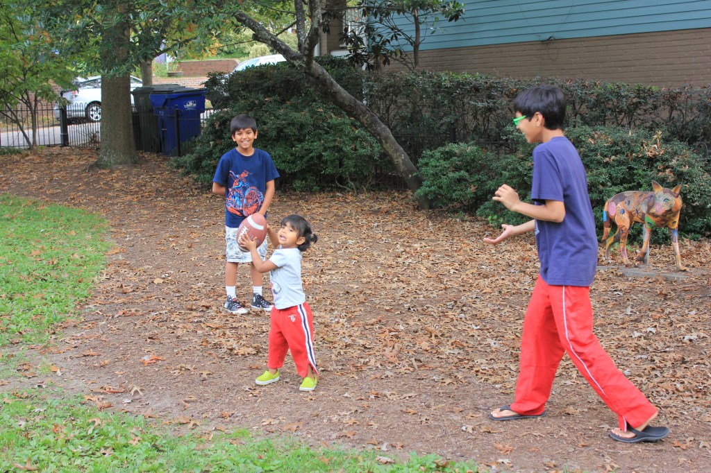 Asha, Eshaan, and Aashrai playing in the playground