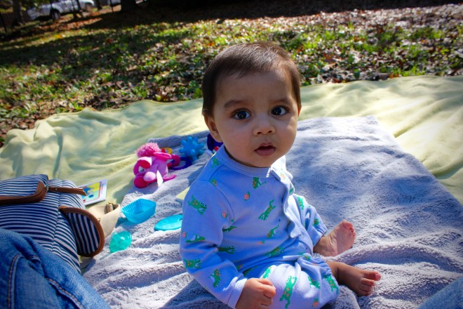 Arjun sitting on a picnic blanket in the park